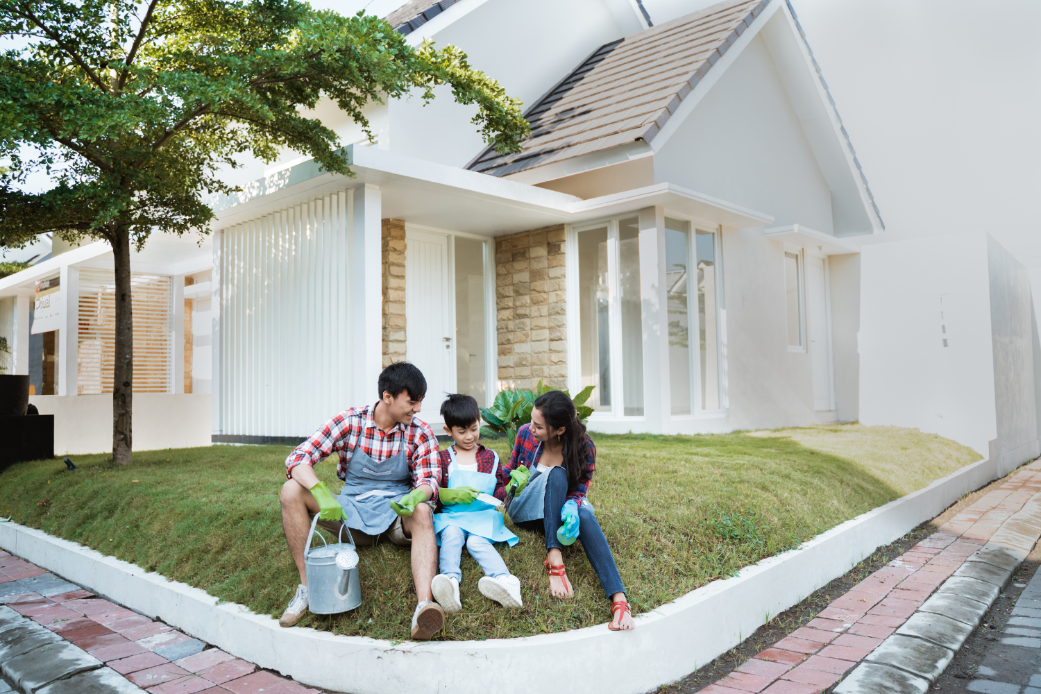 Family sitting in front of house